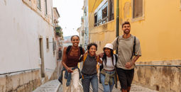 Gen Z travelers walking down the street in Lisbon