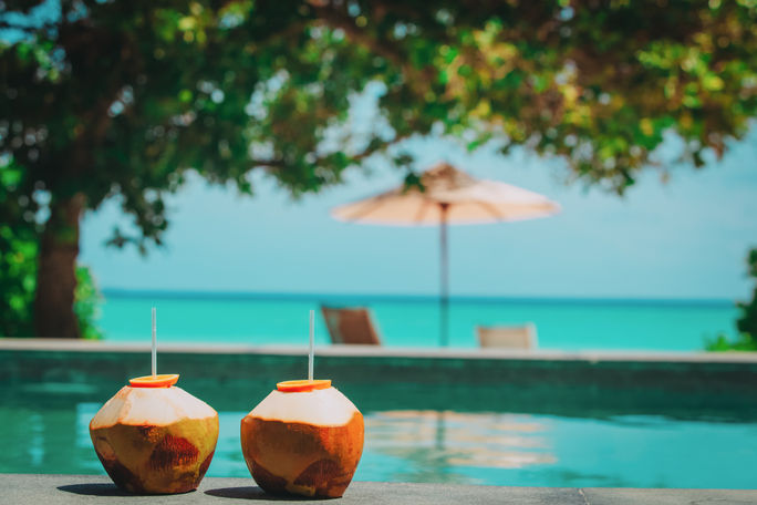 Coconut drinks at a tropical beach resort. Coconut drinks at a tropical beach resort.