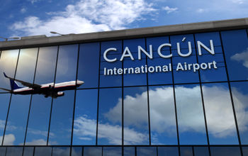 Airplane landing at Cancun International Airport.