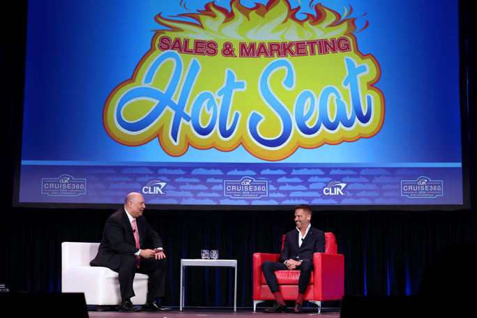 Wayne Spector (left), vice president at NEST, chats with Adolfo M. Perez (right), senior vice president of global sales and trade marketing at Carnival Cruise Line, during Cruise360