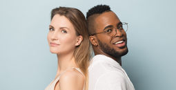 Man and woman standing back-to-back.