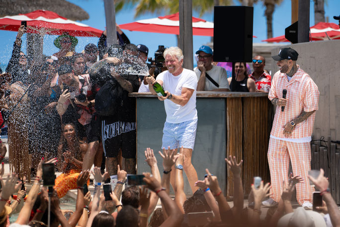 Richard Branson celebrates with champagne in Bimini, Bahamas