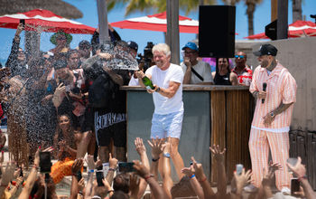 Richard Branson celebrates with champagne in Bimini, Bahamas