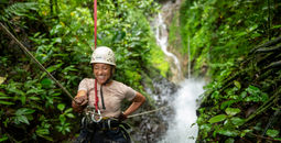G Adventures guest zip-lining during the Solo-ish Costa Rica tour.