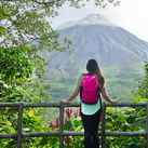 Hiker looking out at the Arenal volcano in La Fortuna