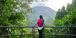 Hiker looking out at the Arenal volcano in La Fortuna