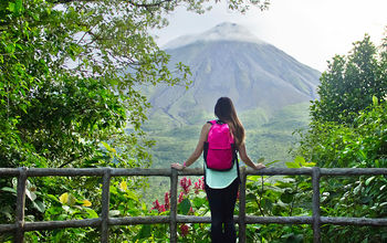Hiker looking out at the Arenal volcano in La Fortuna