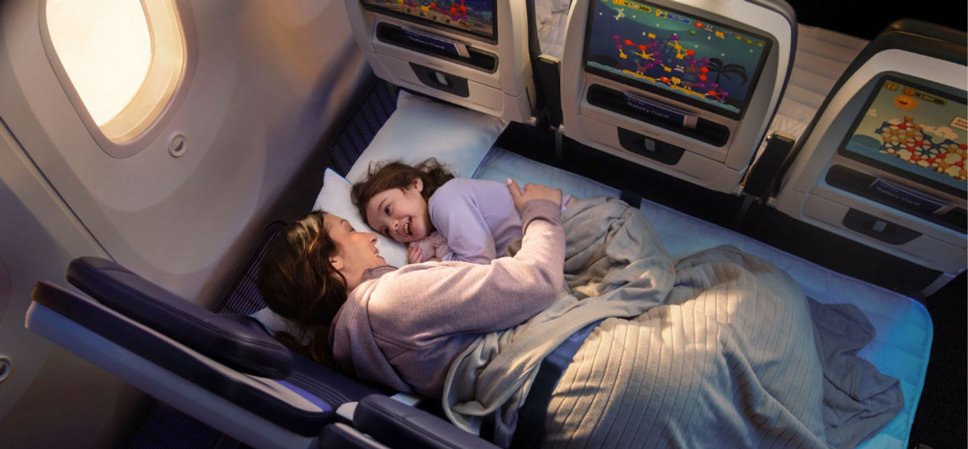 Image: Parent and child lay in United Relax Row (Photo Credit: Courtesy United Airlines)