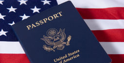 U.S. passport sitting atop an American flag.