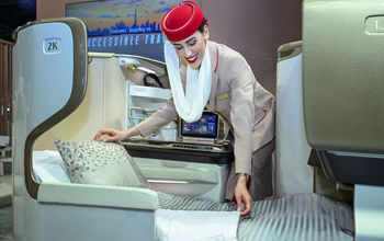 Emirates flight attendant adjusts accessible mattress