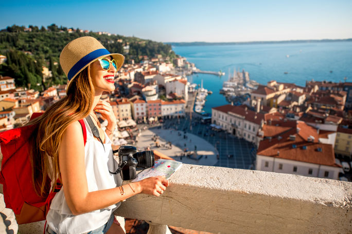 A young female traveler exploring old town Piran, Slovenia. A young female traveler exploring old town Piran, Slovenia.