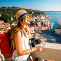 A young female traveler exploring old town Piran, Slovenia.