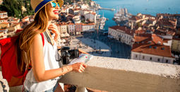 A young female traveler exploring old town Piran, Slovenia.