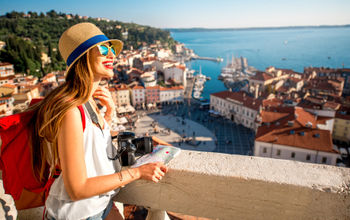 A young female traveler exploring old town Piran, Slovenia.