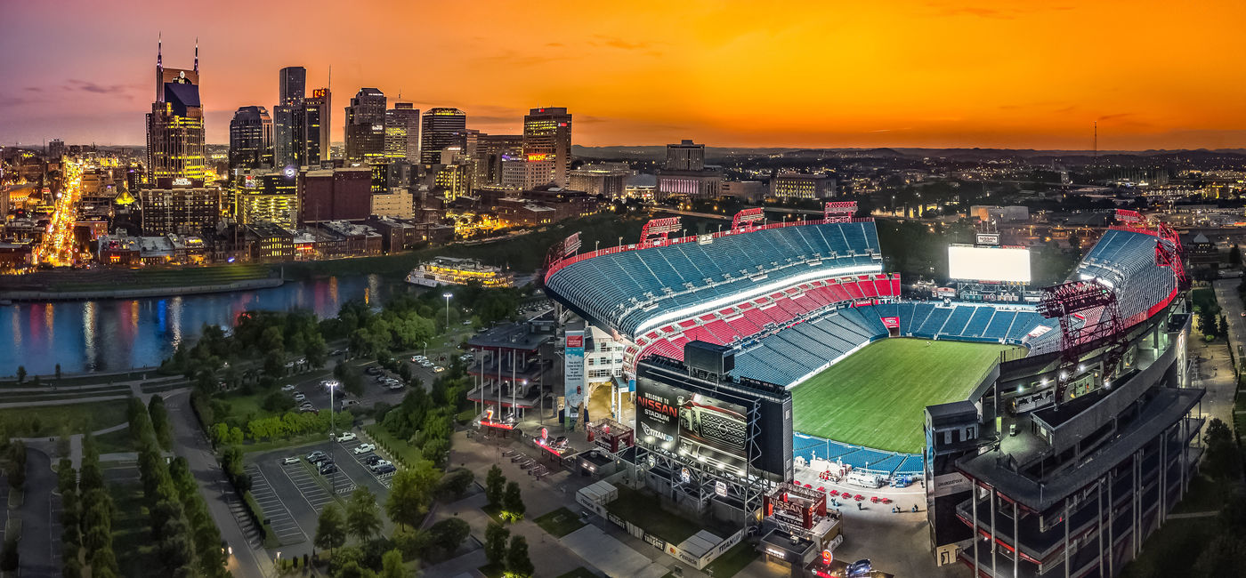Image: Nissan Stadium with city skyline in Nashville, Tennessee. (Photo Credit: Adobe/jdross75)
