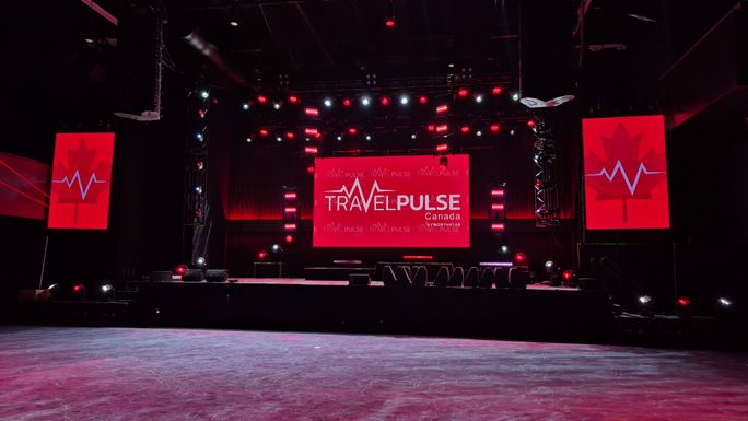 Concert hall screens lit up with TravelPulse Canada's logo, while the stage and hall glowed red and white in our honour (JAG Hotel, NL). Concert hall screens lit up with TravelPulse Canada's logo, while the stage and hall glowed red and white in our honour (JAG Hotel, NL).