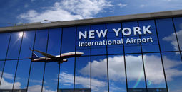 Reflection of airplane landing at New York's JFK International Airport.