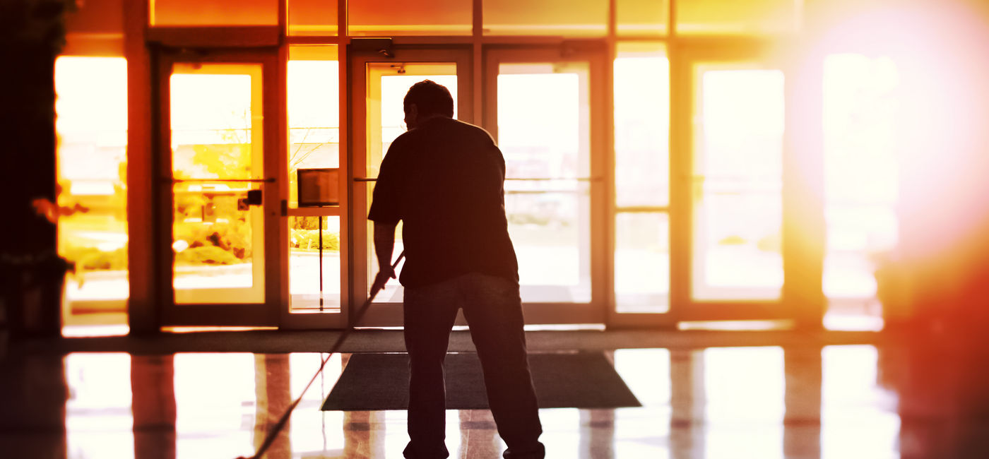 Image: Janitor cleaning a hotel lobby. (Photo Credit: soupstock/Adobe)