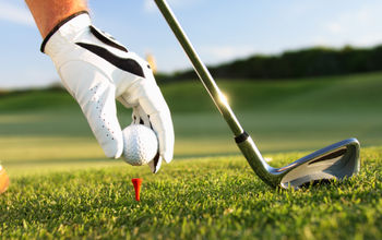 Golfer teeing up a ball