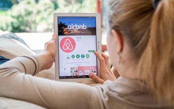 Woman browsing Airbnb listings
