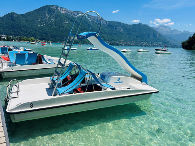 Some of Lake Annecy’s pedal boats have slides affixed to them so guests can splash down into the water.