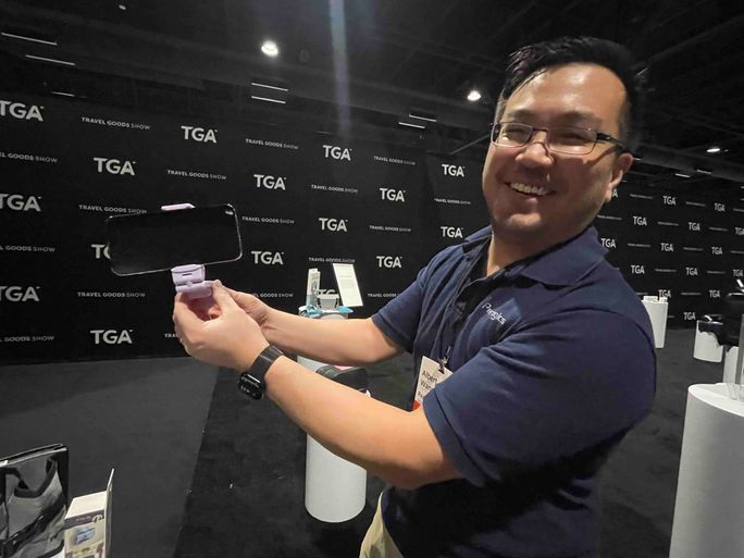 A rep shows off tech device accessories A rep shows off tech device accessories