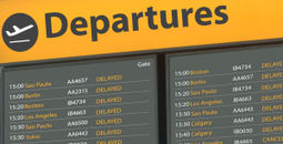 Airport departure board with delayed flights.