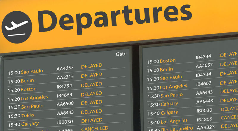 Airport departure board with delayed flights