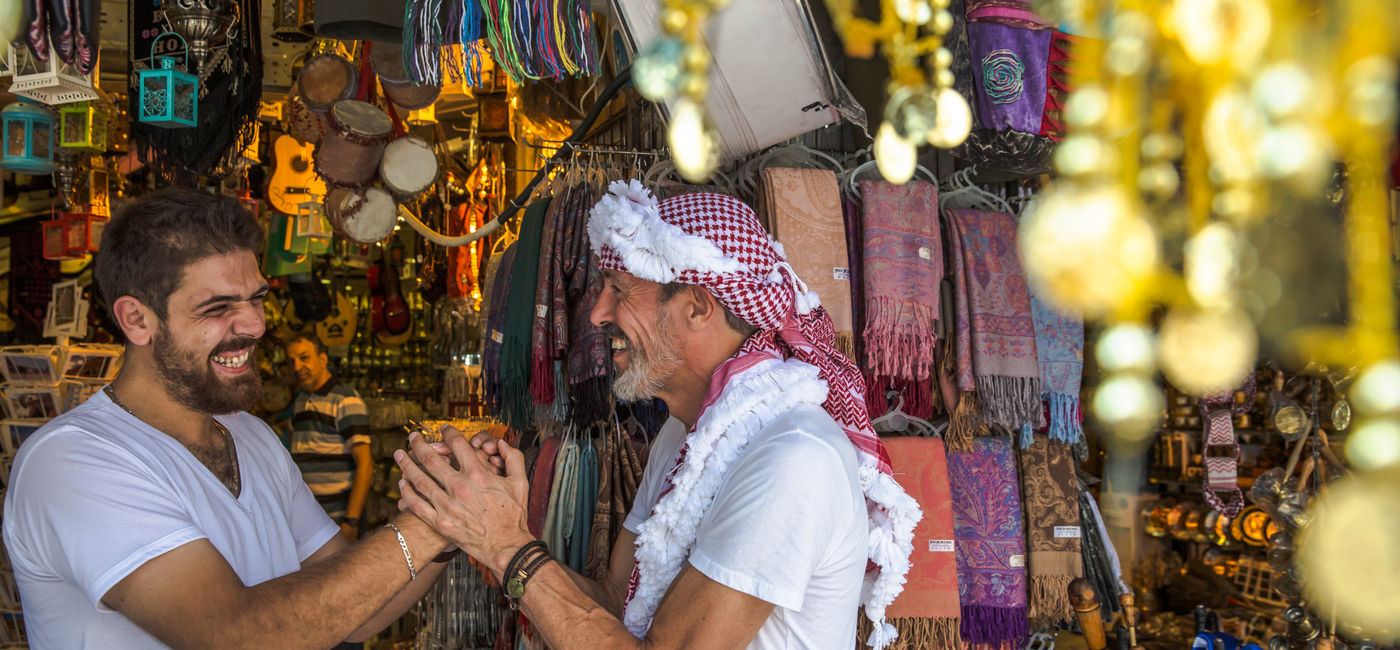 Image: A shop vendor and visitor in Amman, Jordan (Photo Credit: G Adventures)