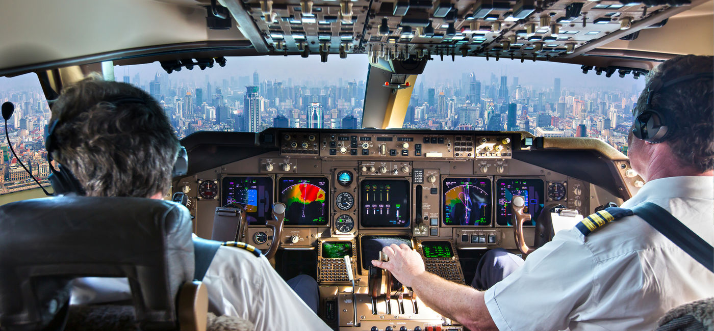 Image: Commercial passenger aircraft pilots in the cockpit. (photo via iStock/Getty Images Plus/AlexeyPetrov)