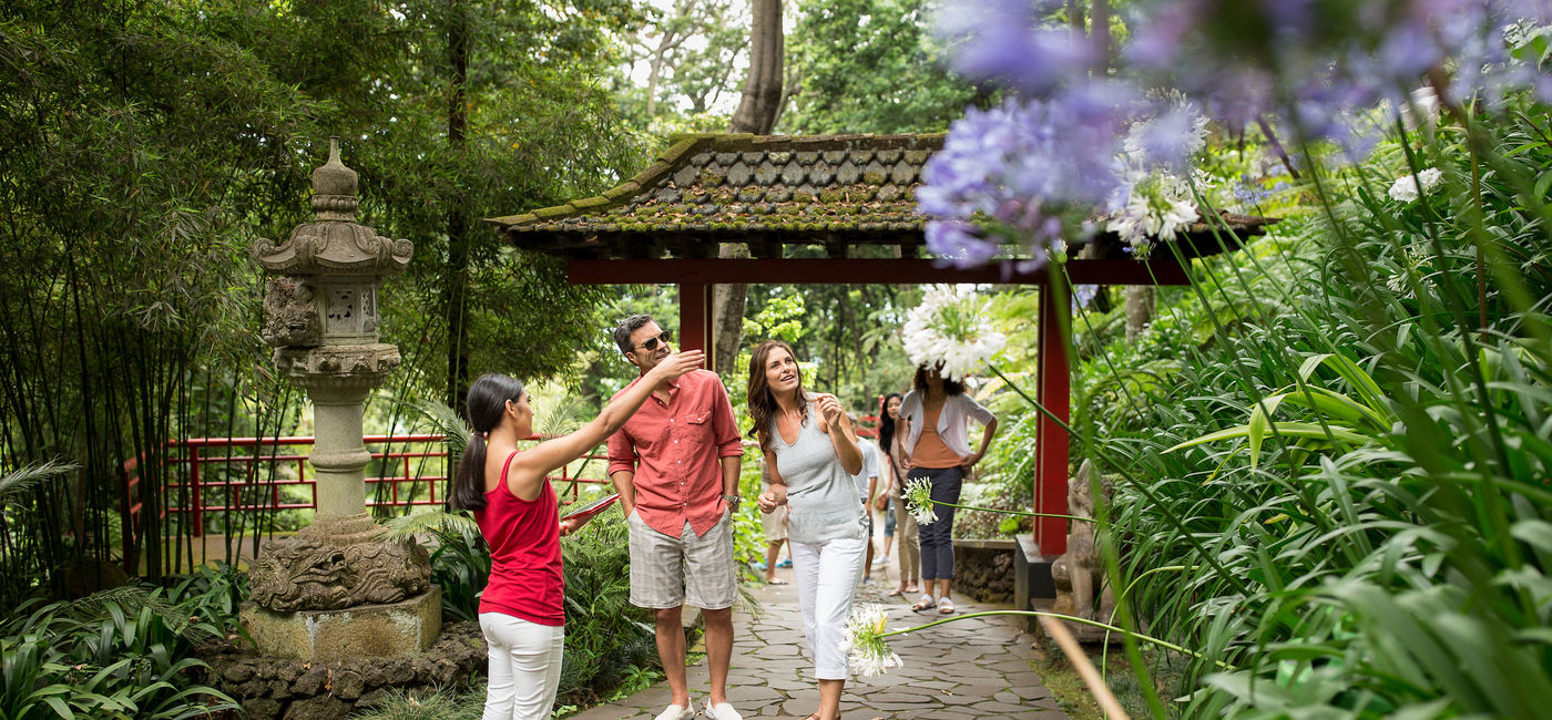 Image: Globus independent travelers tour an Asian garden with a guide.  (Photo Credit: Globus)