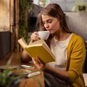 reading, woman reading, solo traveler, book, cafe