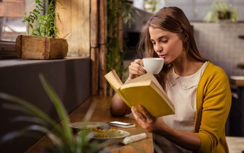 reading, woman reading, solo traveler, book, cafe