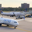 United Airlines planes taxiing on an airport tarmac.