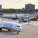 United Airlines planes taxiing on an airport tarmac.