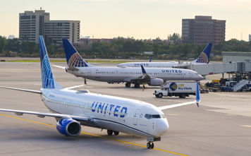 United Airlines planes taxiing on an airport tarmac.