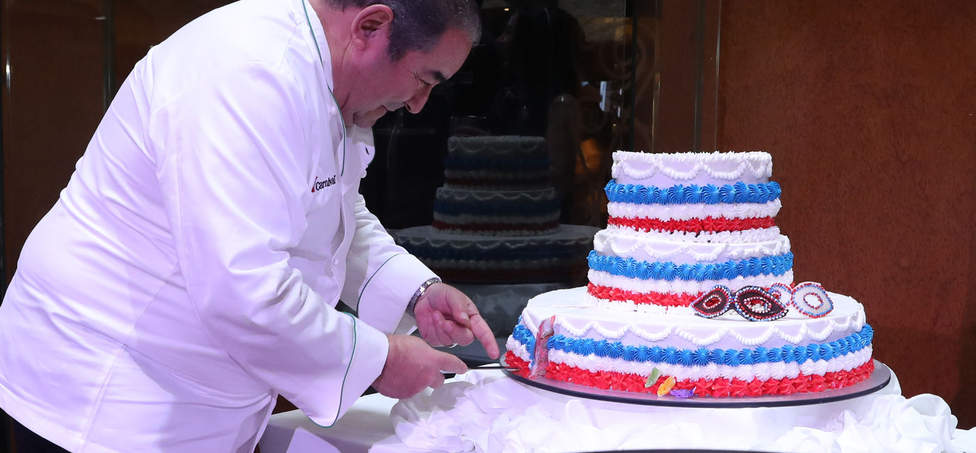 Image: Emeril Lagasse cut the cake for Carnival's anniversary celebration in New Orleans (Photo Credit: Carnival Cruise Line)