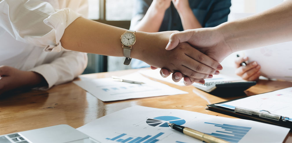 Executives celebrating a business acquisition