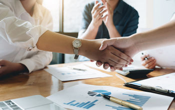 Executives celebrating a business acquisition
