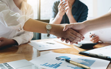 Executives celebrating a business acquisition