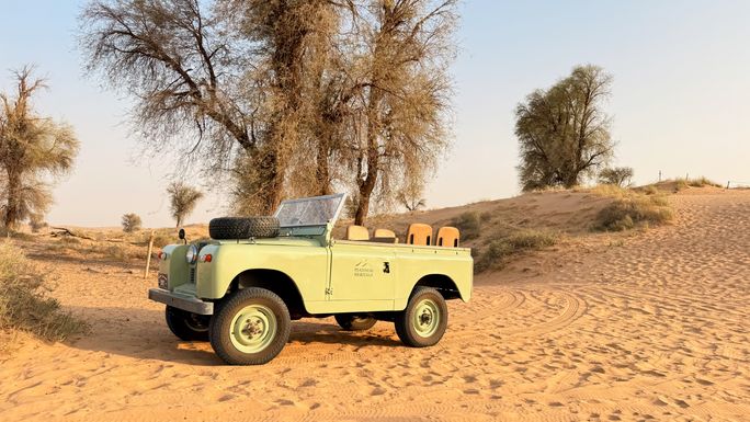 Guests are driven through the park in open-top vintage Land Rovers. Guests are driven through the park in open-top vintage Land Rovers.