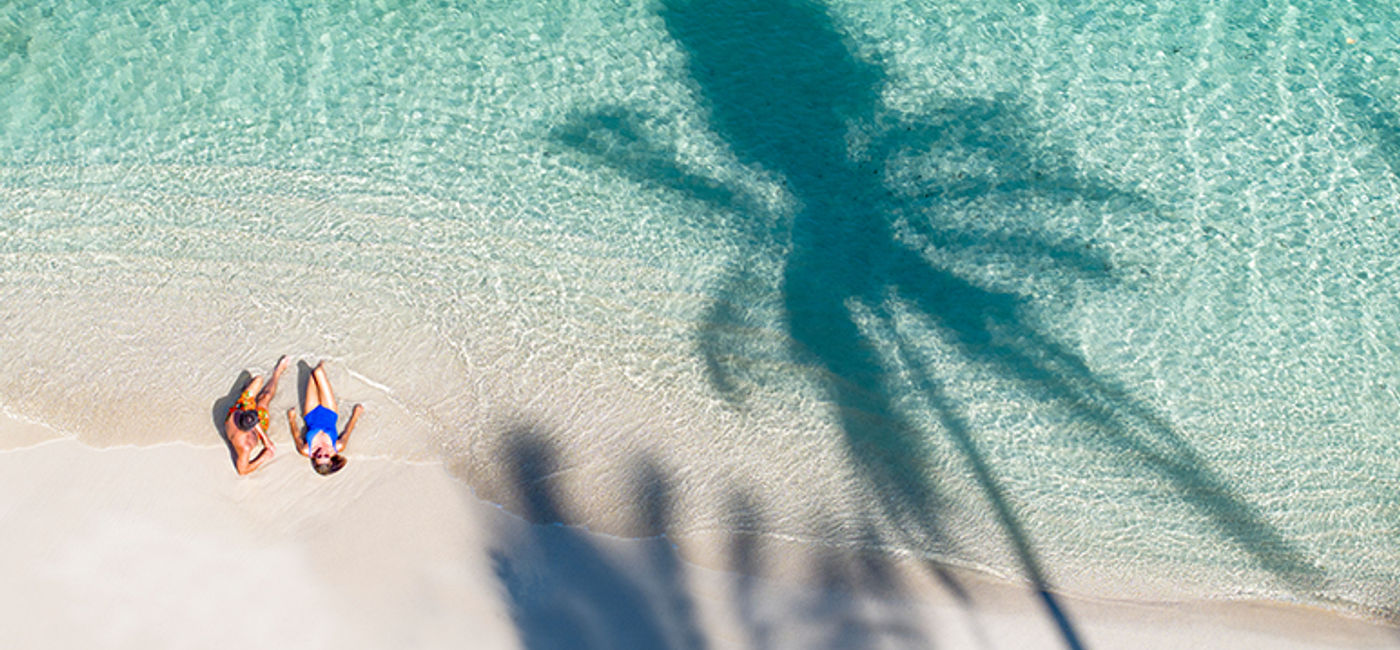 Image: A couple at a lagoon on Moorea (Photo Credit: Paul Gauguin Cruises)