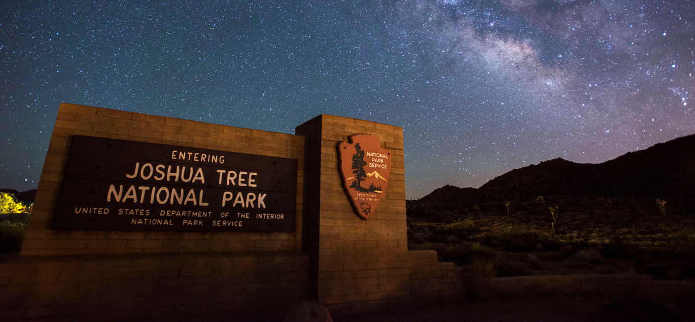Image: Joshua Tree National Park sign under the stars (Photo via NPS/Lian Law) (Photo Credit: (photo via NPS/Lian Law))