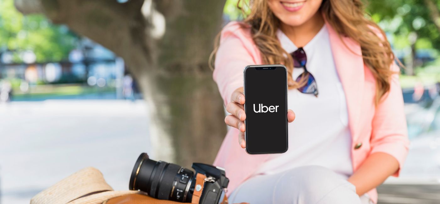 Image: Woman using the Uber app open on her smartphone. (Photo Credit: Uber)