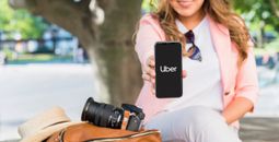Woman using the Uber app open on her smartphone.