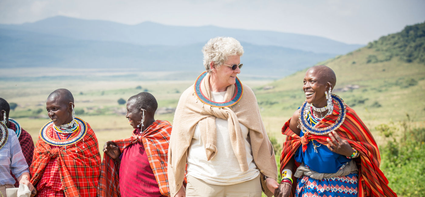 Image: A traveler speaks with a Maasai Mara woman in Tanzania. (Source: Abercrombie & Kent)