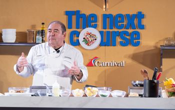 Chief Culinary Officer Emeril Lagasse puts on a cooking demo showcasing one of Carnival's culinary creations