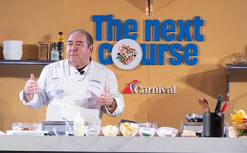 Chief Culinary Officer Emeril Lagasse puts on a cooking demo showcasing one of Carnival's culinary creations