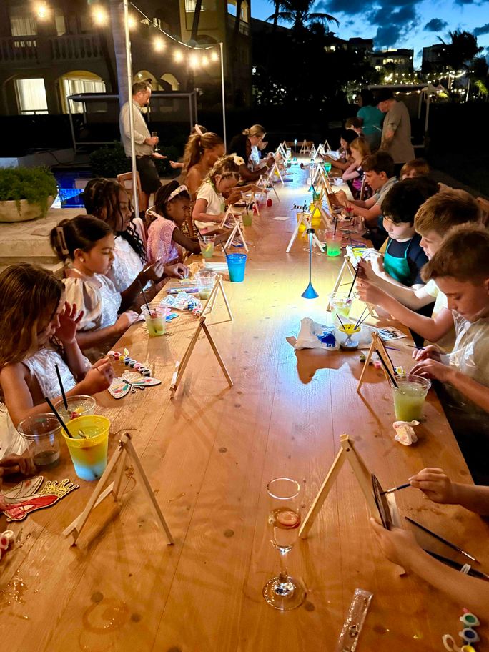 Young guests at Grace Bay Resort spend the evening painting by the beach Young guests at Grace Bay Resort spend the evening painting by the beach