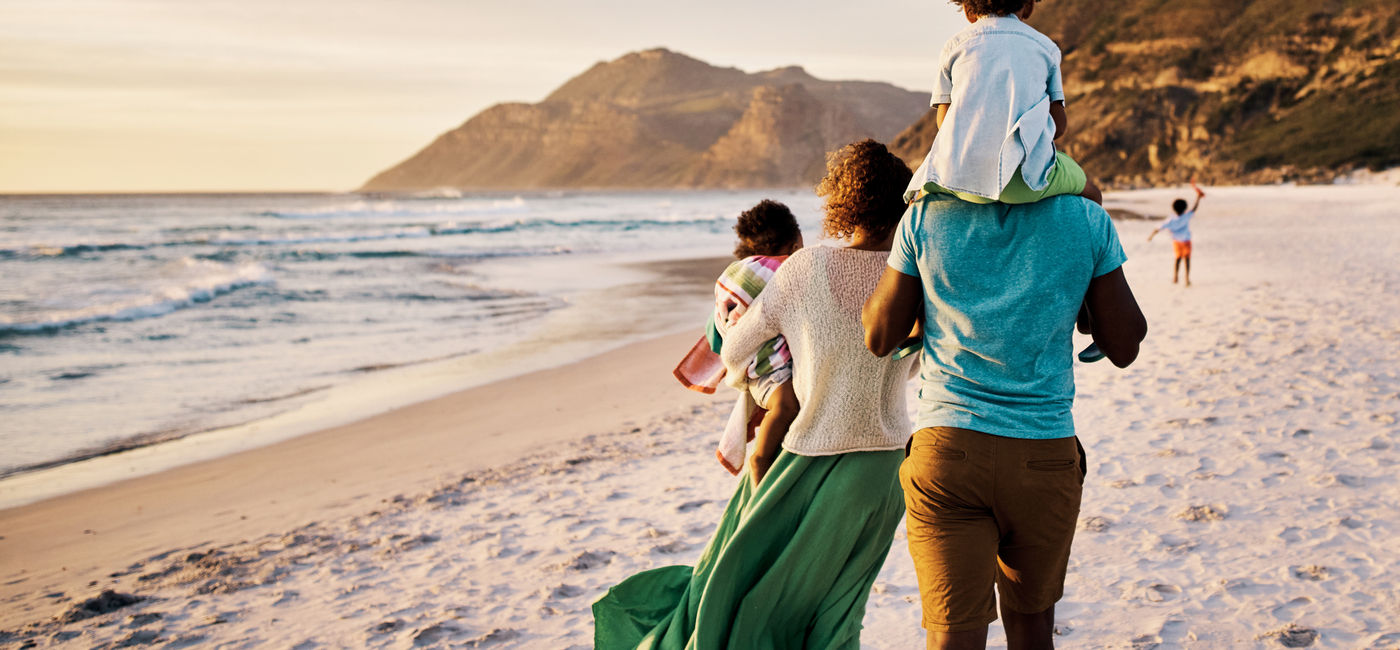 Image: Family enjoying a beach vacation. (Photo Credit: pixdeluxe/E+)